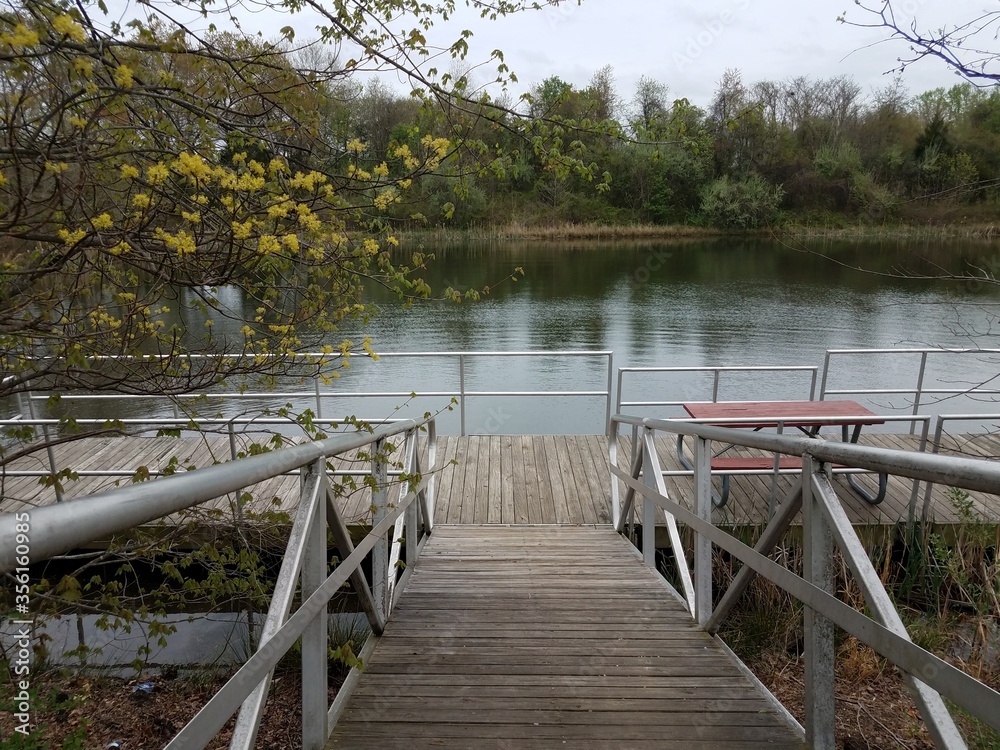 wooden walkway or ramp floating platform and picnic table and lake