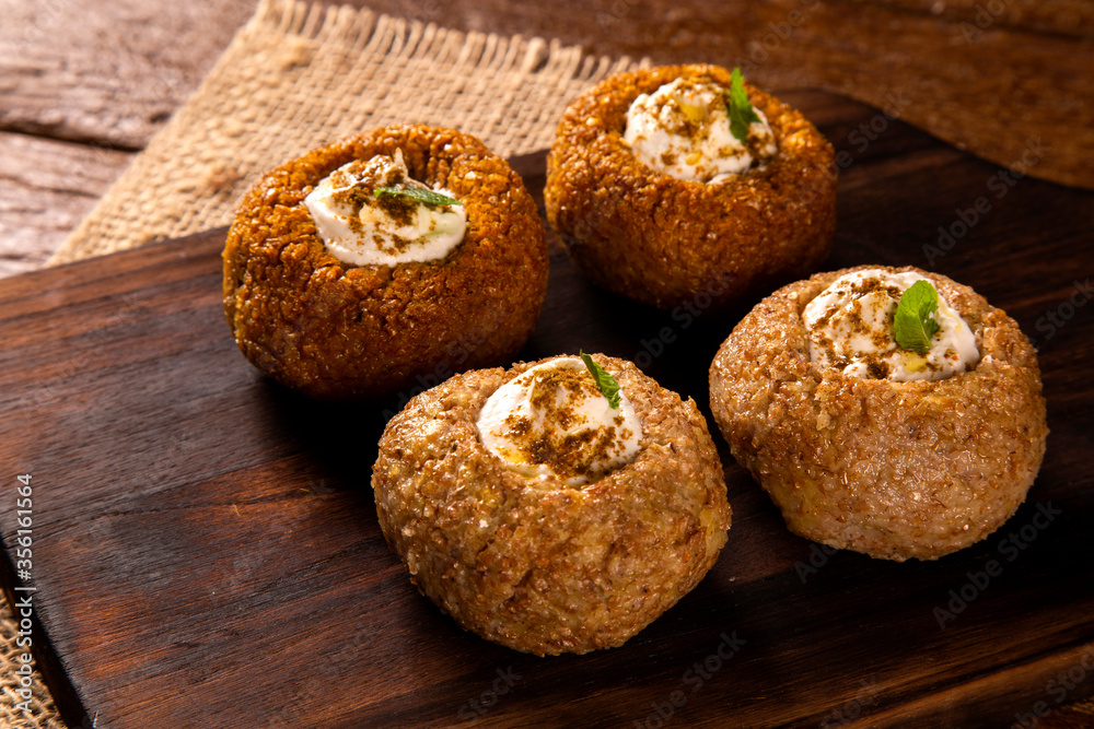 kibe stuffed with dry curd on wood background. kibe stuffed with dry curd on wood background.