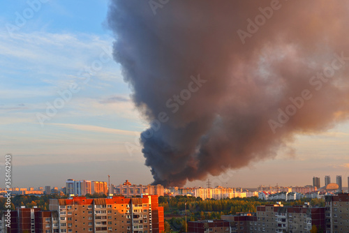 Fire on sunset in Moscow, Russia. Black smoke in whole sky