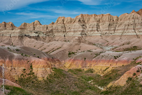 Reds, yellows, oranges and browns color the arid rocks, ridges and cliffs in the rugged Badlands of South Dakota.