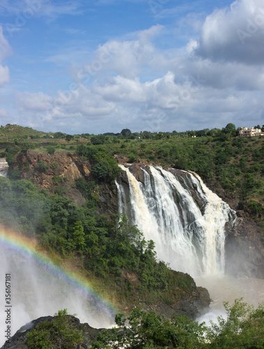 The Ferocious Waterfalls with a rainbow and the blue sky at Shivanasamudra near Mysuru in Karnataka / India.