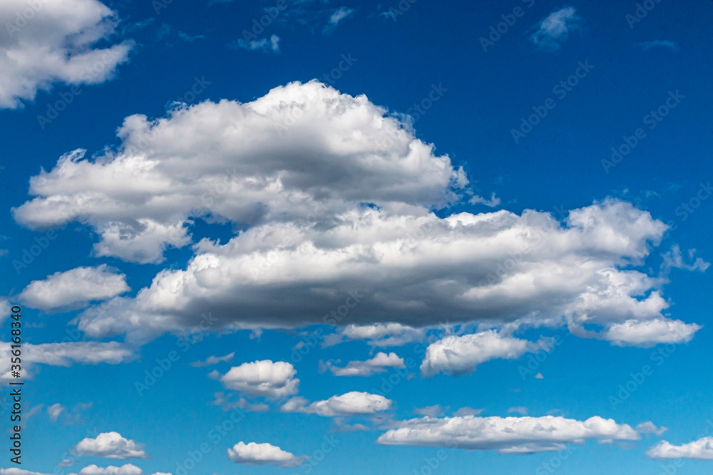 Fototapeta premium Puffy white clouds in a blue sky