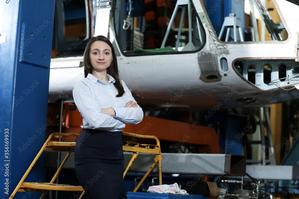 custom made wallpaper toronto digitalPortrait of a solid businesswoman holding tablet , controlling work process in a airplane manufactory. Office worker.