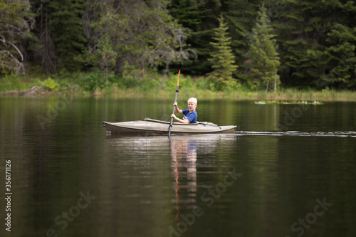 Boy kayaking on Moose Creek Reservoir in northern Idaho
