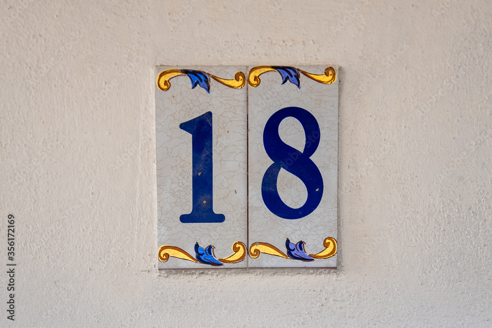 Ceramic number and symbols signs outside the house in Granada, Andalucia, South of Spain Ceramic number and symbols signs outside the house in Granada, Andalucia, South of Spain
