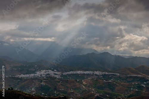 Storm clouds surrounding the Moorish village of Frigiliana nestling in the mountains, Costa del Sol, Andalucia, Spain