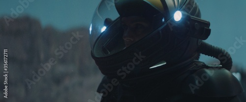 фотографія Caucasian female astronaunt wearing a space suit exploring planet surface, night