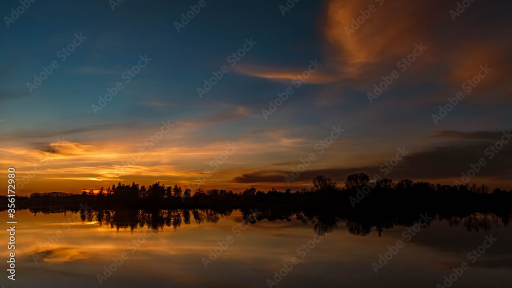 Beautiful sunset with reflections at Ettling, Isar, Bavaria, Germany