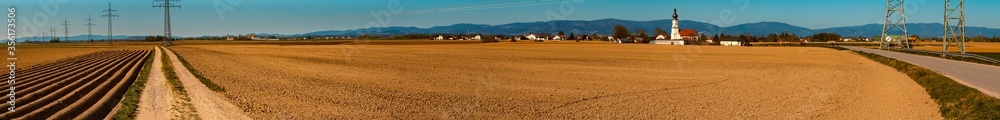 High resolution stitched panorama of a beautiful spring view with field furrows and the famous pilgrimage church to the holy cross at Loh, Bavaria, Germany High resolution stitched panorama of a beautiful spring view with field furrows and the famous pilgrimage church to the holy cross at Loh, Bavaria, Germany