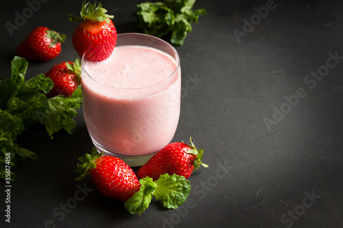 Strawberry smoothie, fresh berries, healthy eating, dieting food, black background.