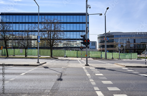 Street with pedestrian crossing and new unfinished office building in the background
