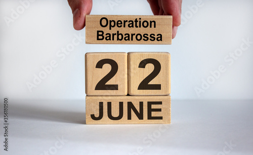Male hand puts a block with the inscription 'operation barbarossa' on cubes with the date June 22th. Beautiful white background, copy space. photo