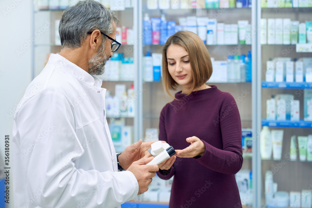 Female customer and pharmacist choosing medicine. Female customer and pharmacist choosing medicine.