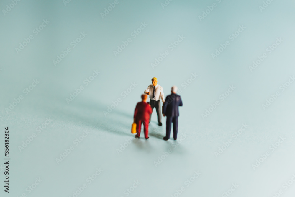 Miniature businessman and businesswoman talking together using as business meeting and business teamwork concept Miniature businessman and businesswoman talking together using as business meeting and business teamwork concept