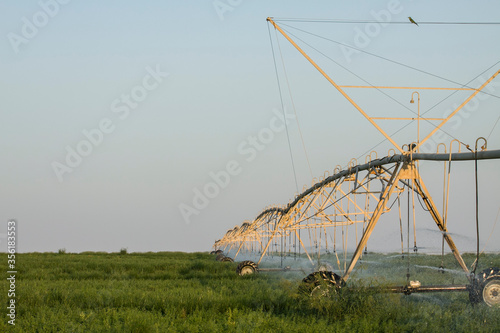 farming by using circle irrigation, pipes, sprinklers and pivots  photo