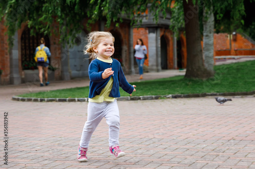 Photography Cute little happy toddler girl running in park in Dublin, Ireland