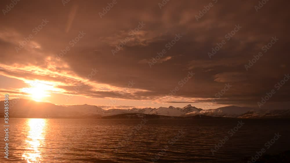 golden sunset over fjord and mountains in northern Norway golden sunset over fjord and mountains in northern Norway