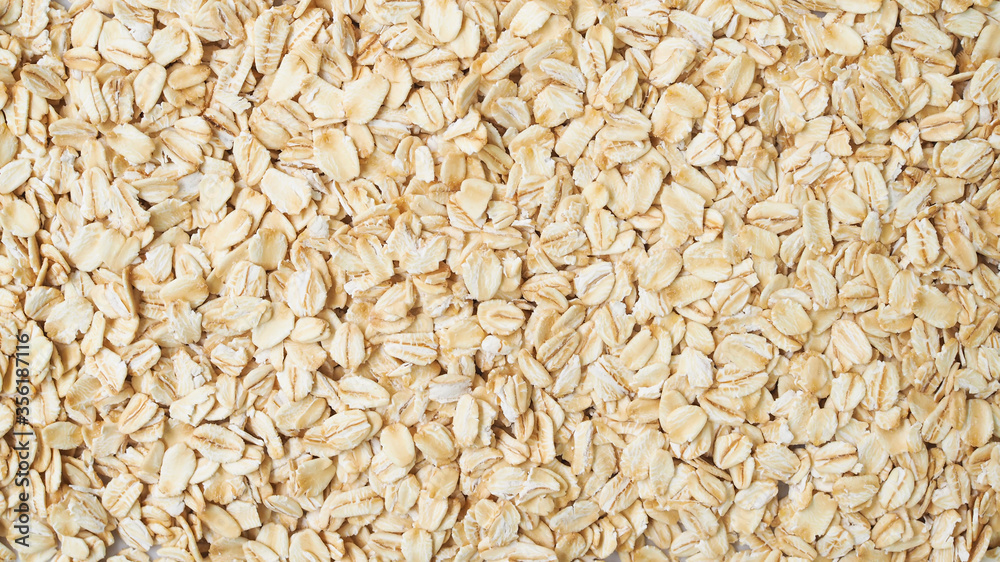 Wallpaper of Rolled oat flakes cereal whole grain background. Wallpaper of Rolled oat flakes cereal whole grain background.