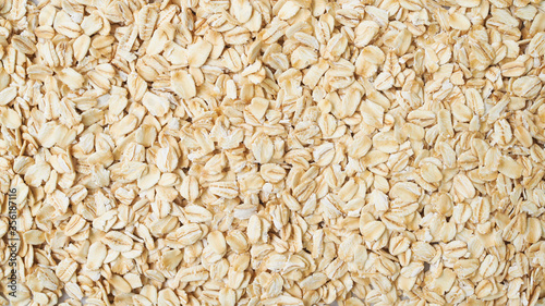 Wallpaper of Rolled oat flakes cereal whole grain background.