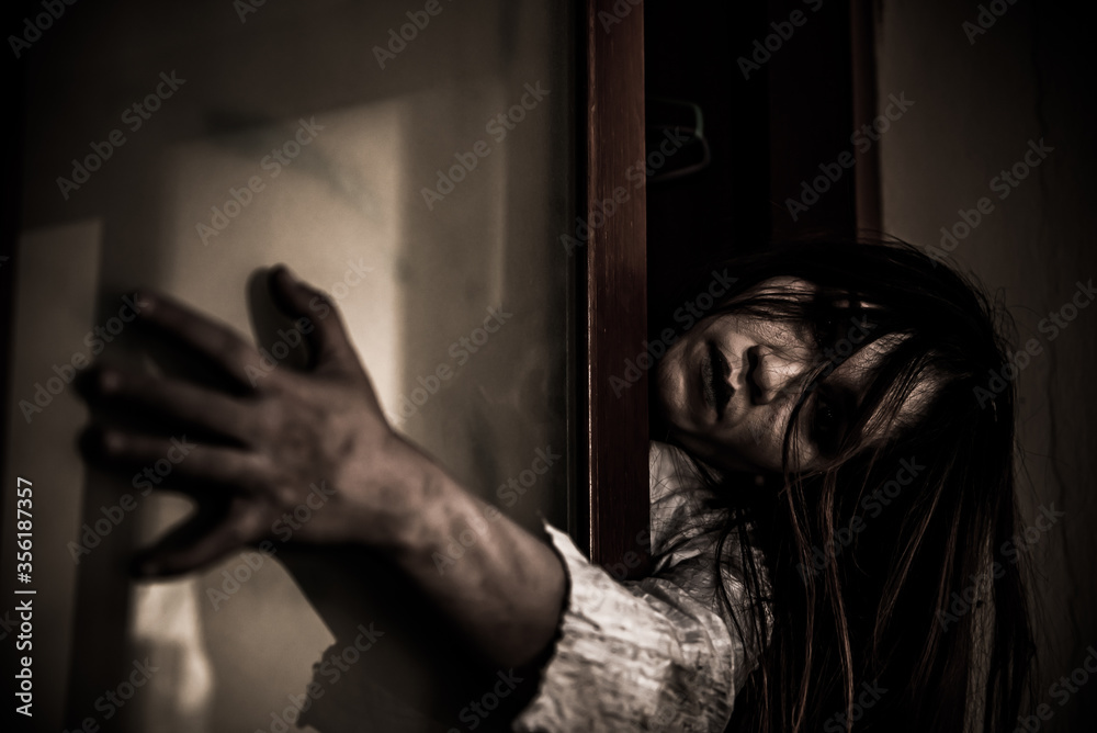 Portrait of asian woman make up ghost face with blood,Horror scene,Scary background,Halloween poster,Thailand people,Ghost movies poster Portrait of asian woman make up ghost face with blood,Horror scene,Scary background,Halloween poster,Thailand people,Ghost movies poster