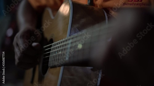 Guitarist  playing acoustic guitar in relax time  , man finger holding a bar chord photo