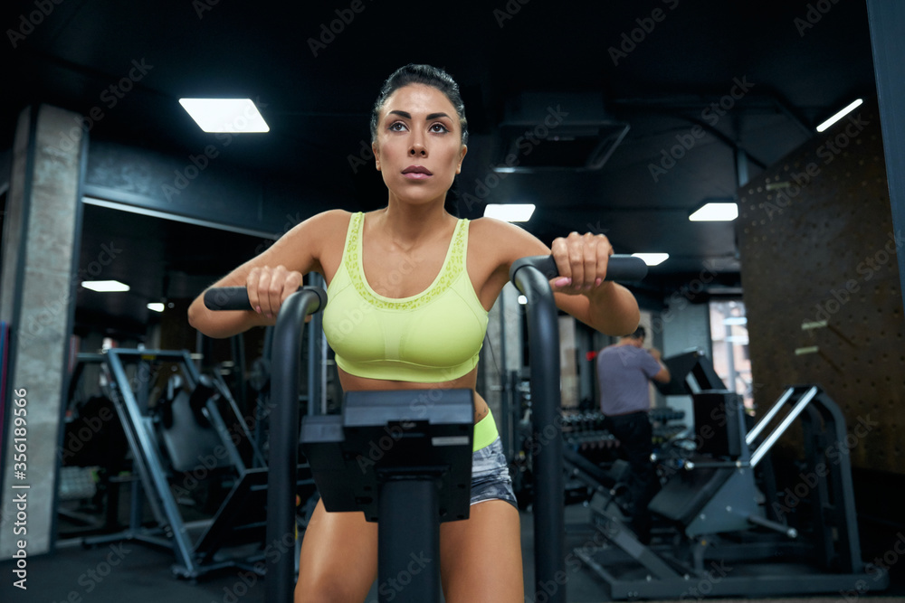 Fototapeta premium Fit woman doing cardio in gym.