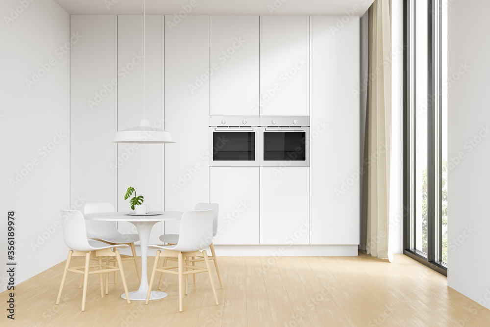 Fototapeta premium Side view of the white interior of the kitchen and dining room with wooden floors, a white suite, a table and chairs and a large window. 3d rendering.
