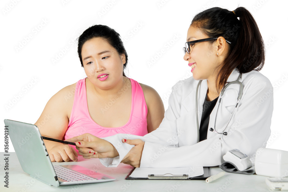 Doctor showing medical result to her fat patient Doctor showing medical result to her fat patient