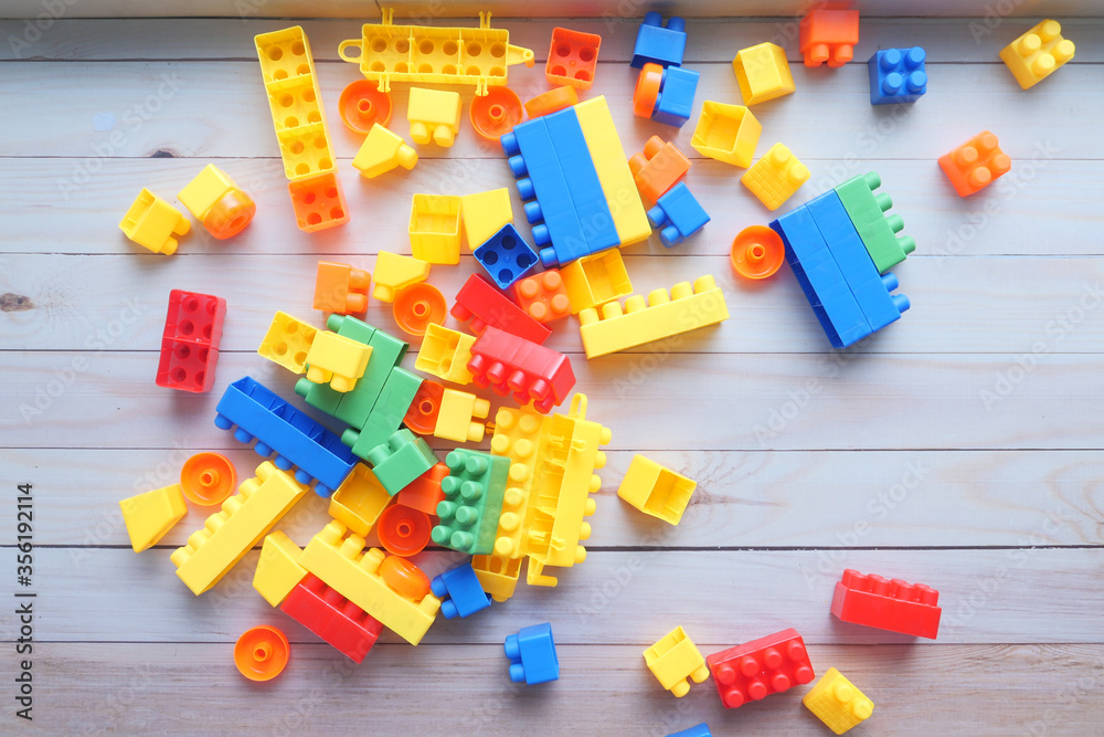 Obraz premium colorful building blocks on wooden table , top view 