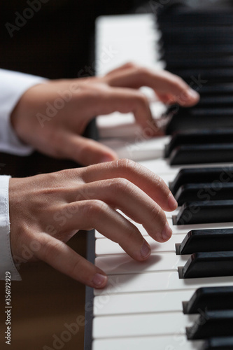 Closeup hands man playing piano. music instrument.