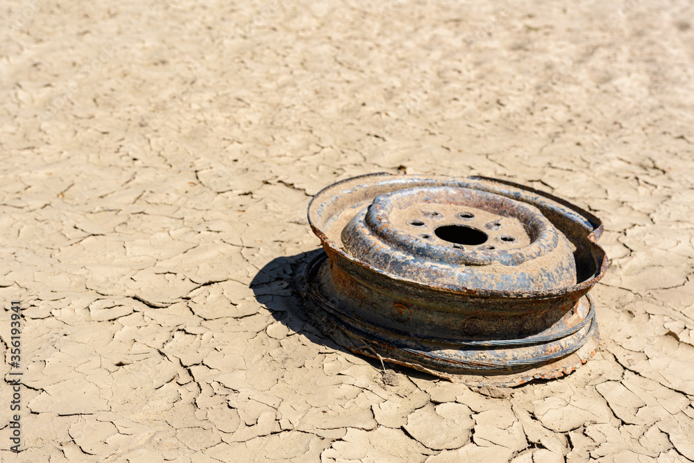 Pollution, abandoned vehicle tire on the river bank. Pollution, abandoned vehicle tire on the river bank.