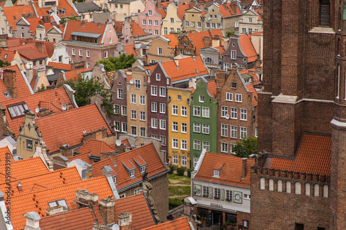Gdansk, Poland - Juny, 2019: Red roofs, old buildings and colorful houses in Old Town Stare Miasto in Gdansk, aerial view from cathedral St. Mary's Church tower, Poland