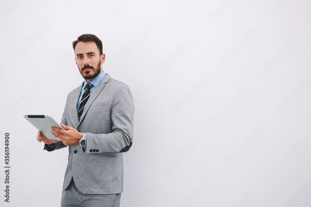 Serious male CEO is reading resume specialists before interview Serious male CEO is reading resume specialists before interview