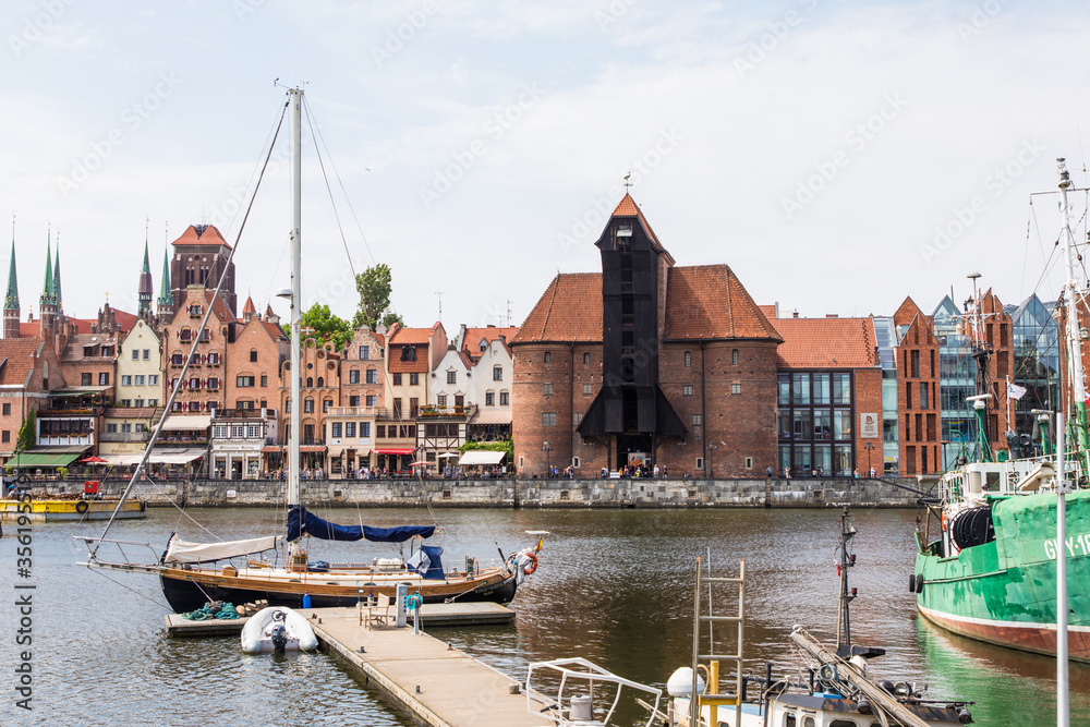 Fototapeta premium Gdansk, Poland - Juny, 2019. Gdansk old town and famous crane, Polish Zuraw. View from Motlawa river. The city also known as Danzig and the city of amber.