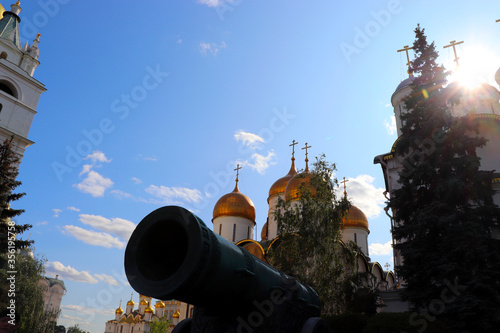 Tsar Cannon in the Moscow Kremlin, the Assumption Cathedral and the Cathedral of the Annunciation under the blue sky