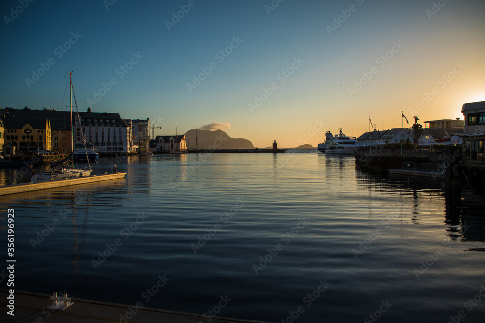 Gdansk, Poland - Juny, 2019: Scenic secessionist houses in european Alesund town reflected in water at Romsdal region in Norway