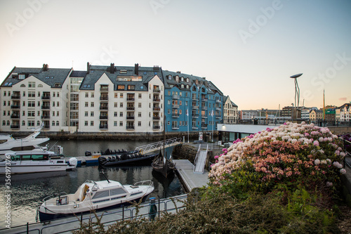 Gdansk, Poland - Juny, 2019: Scenic secessionist houses in european Alesund town reflected in water at Romsdal region in Norway photo