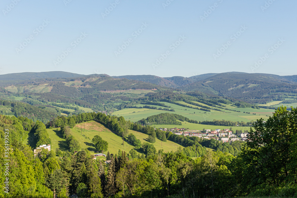 Spruce forests in the mountains with a beautiful sky on a sunny day, Czech Jeseniky mountains