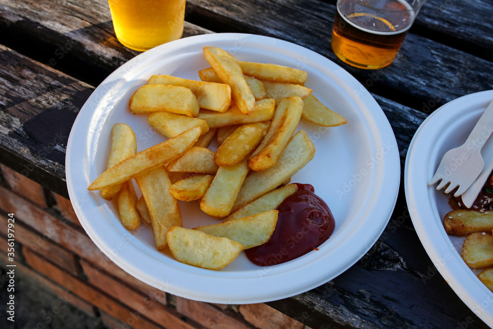 street food: french fries with ketchup and beer street food: french fries with ketchup and beer