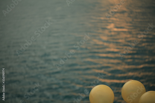 yellow lantern on a background of blue sea © Misha