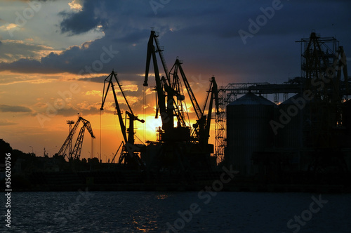 Sea port and industrial cranes, Odessa, Ukraine. Sunset