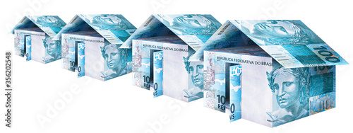 several houses built with money, 100 reais from brazil, rental concept or social project, real estate market or residential investment.