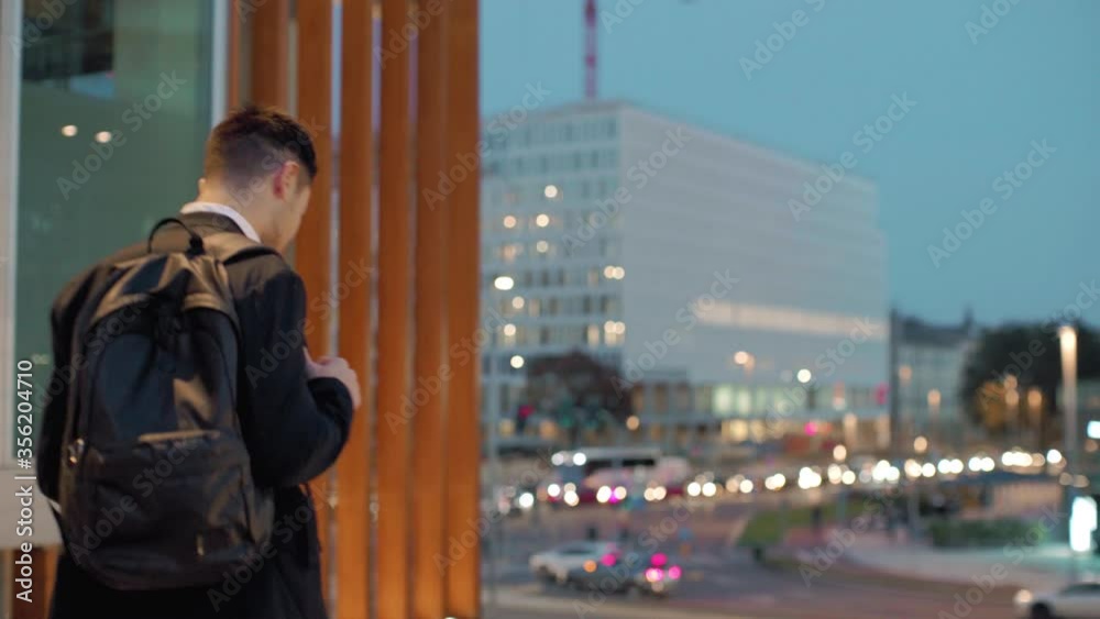 MS TS WS Businessman walking in city and using smart phone / Milan, Italy