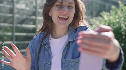 5g mobile technology. Joyful girl communicates with relatives by video call on the street