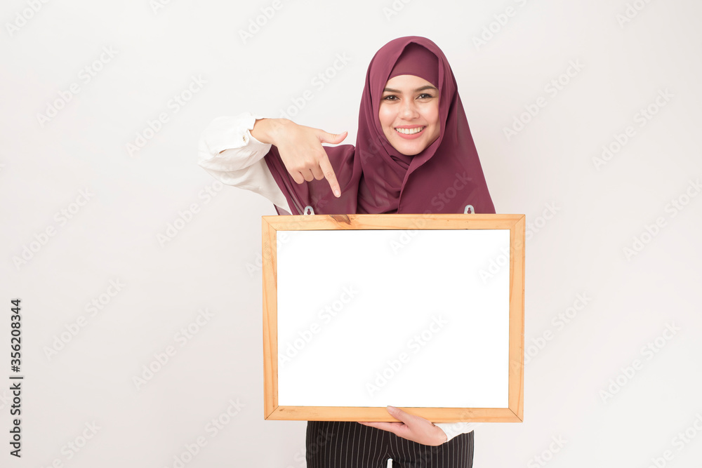 Portrait of woman with hijab is holding frame mockup Portrait of woman with hijab is holding frame mockup