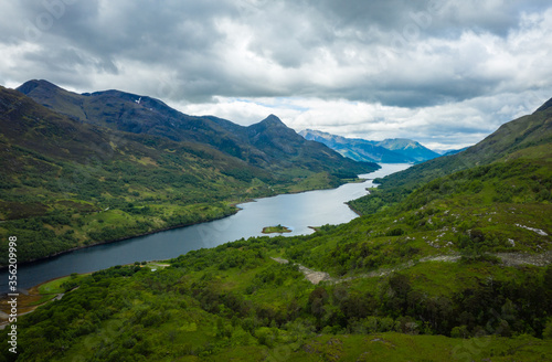 a view over loch leven from the west highland way near kinlochleven and fort william in the argyll region of the highlands of scotland during a warm spring day showing green forest and hillsides © Andy Morehouse