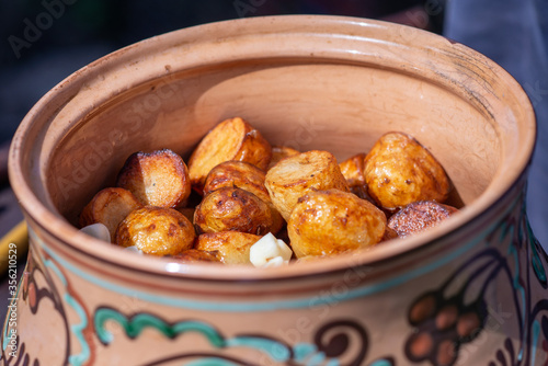 Grilled potato on frying pan in clay pot