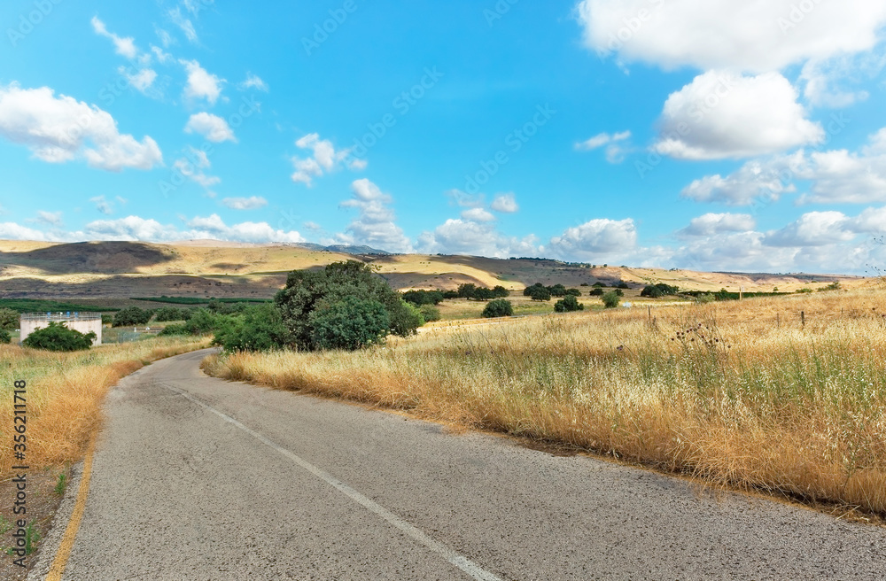 Road in the Golan Heights against the backdrop of beautiful clouds