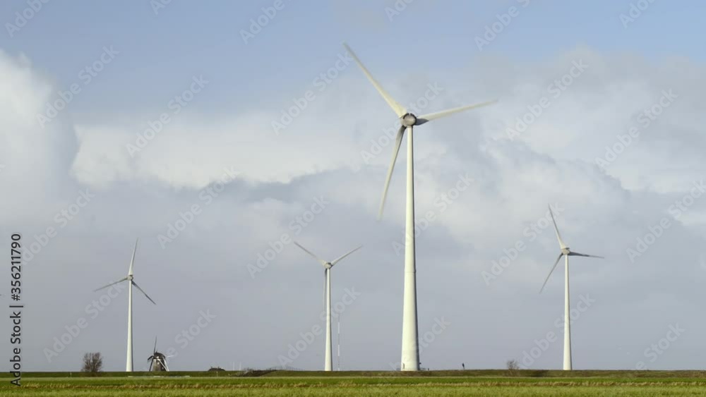 WS Historical windmill Goliath near wind turbines in Eemshaven harbor area / Delfzijl, Groningen, Netherlands WS Historical windmill Goliath near wind turbines in Eemshaven harbor area / Delfzijl, Groningen, Netherlands
