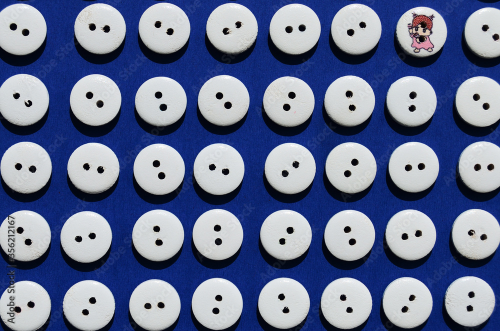 Pattern white wooden buttons on a blue background view from above one baby from the cartoon Pattern white wooden buttons on a blue background view from above one baby from the cartoon
